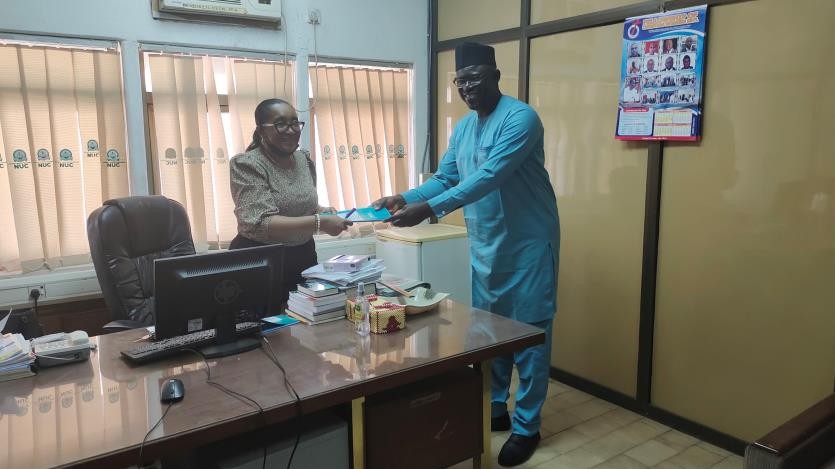 Dr. Mrs Margaret Ekenna receiving the project brief from the Dissemination Team